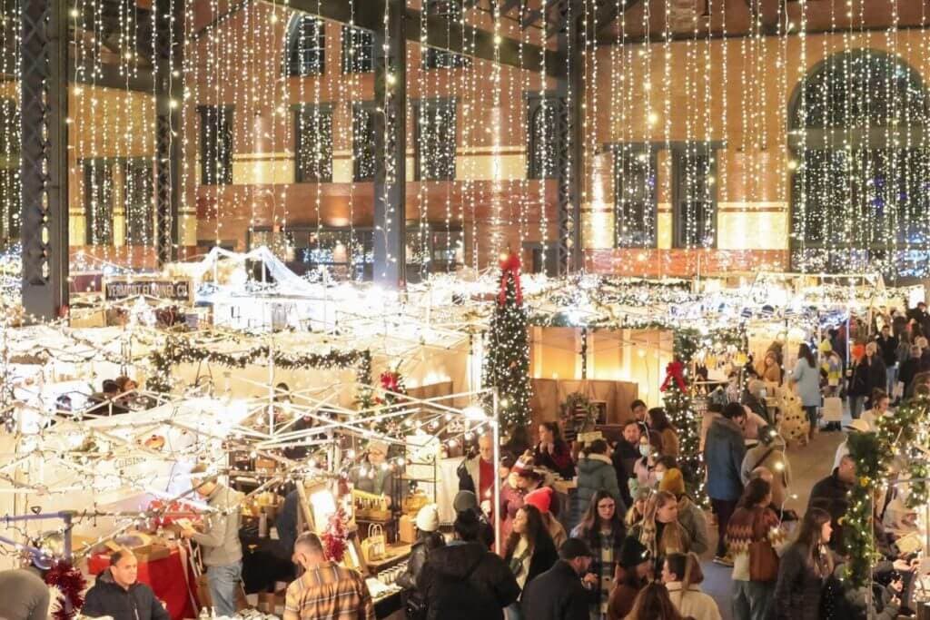 Twinkling lights hang over the stalls at the SoWA Winter Festival.